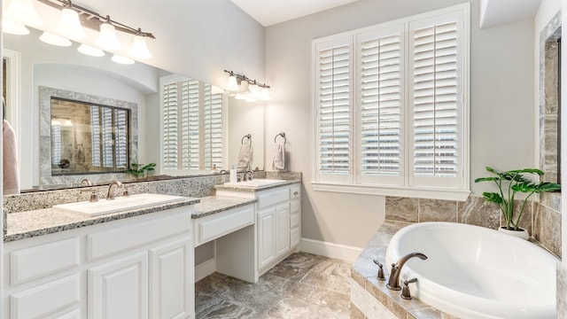 bathroom with vanity and tiled tub