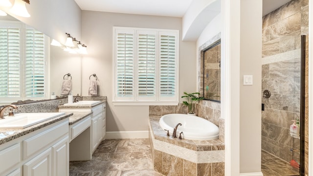 bathroom featuring separate shower and tub, vanity, and plenty of natural light