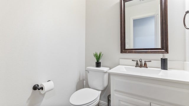 bathroom featuring toilet and vanity