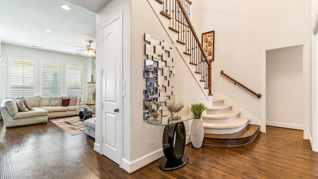 staircase featuring hardwood / wood-style flooring and ceiling fan