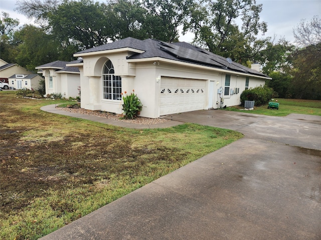 single story home with a front yard and a garage