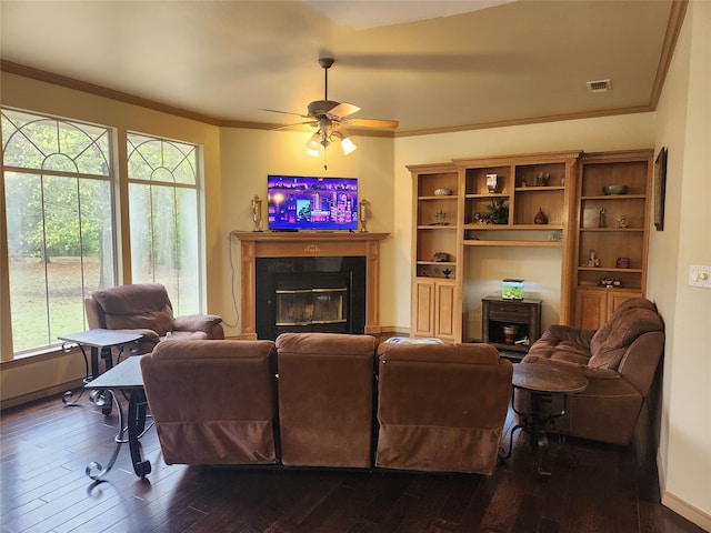 living room with ornamental molding, dark hardwood / wood-style floors, and plenty of natural light