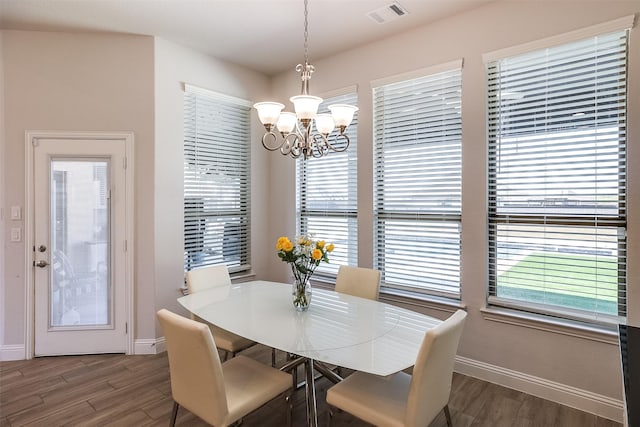 dining room featuring a wealth of natural light, visible vents, and wood finished floors