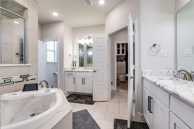 bathroom with separate shower and tub, vanity, and tile patterned flooring