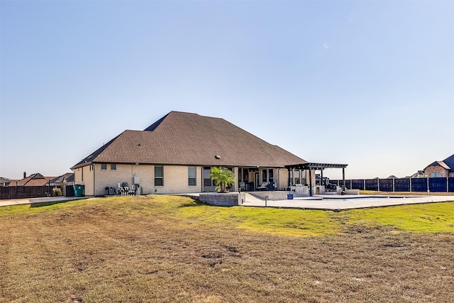 rear view of house featuring a lawn, a patio area, fence, and a pergola