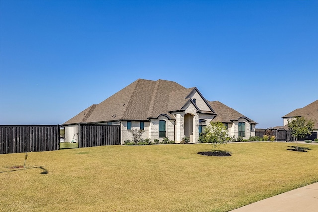 french provincial home featuring a front lawn