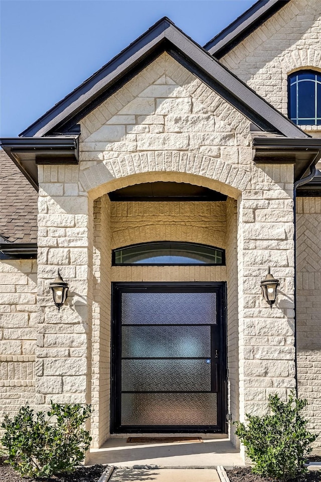 property entrance featuring brick siding