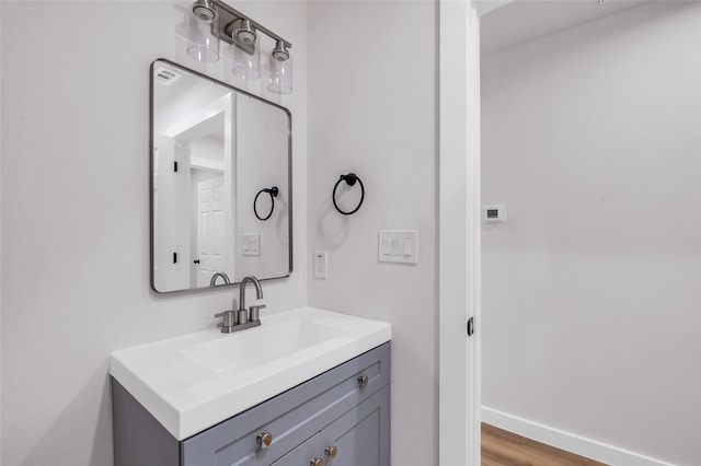 bathroom with vanity and wood-type flooring