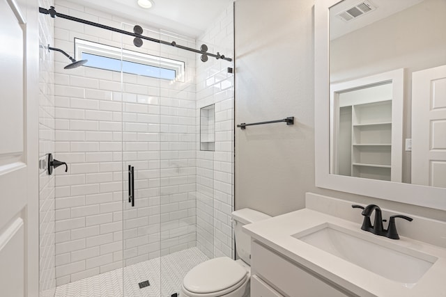 bathroom featuring toilet, an enclosed shower, and vanity