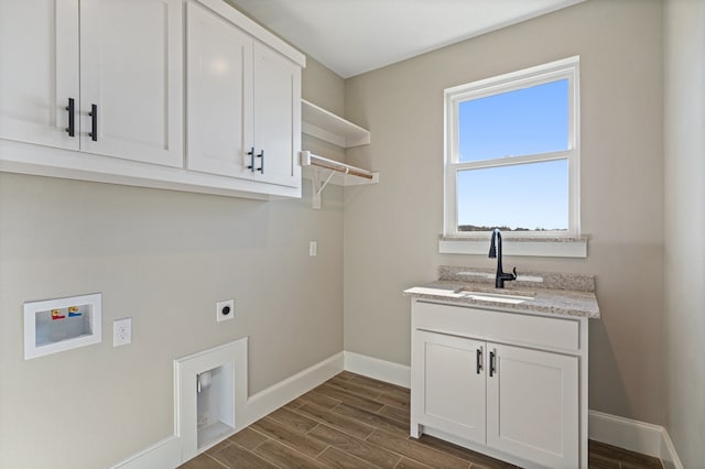 laundry room featuring cabinets, hookup for a washing machine, dark hardwood / wood-style floors, electric dryer hookup, and sink