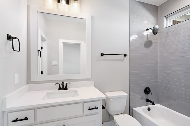 full bathroom featuring toilet, tiled shower / bath, and vanity