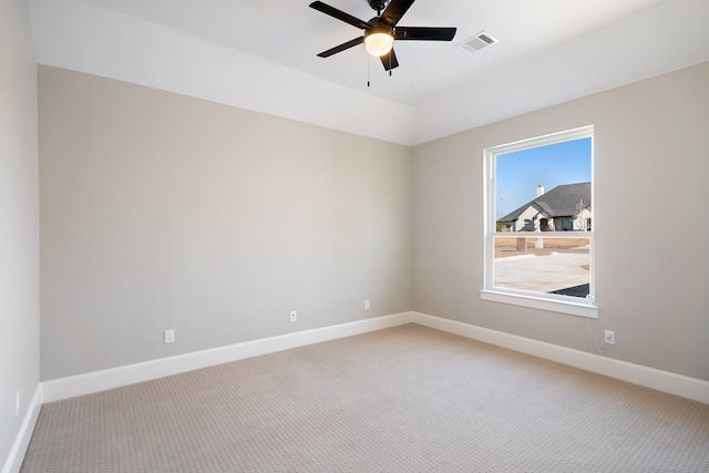 empty room featuring ceiling fan and light colored carpet