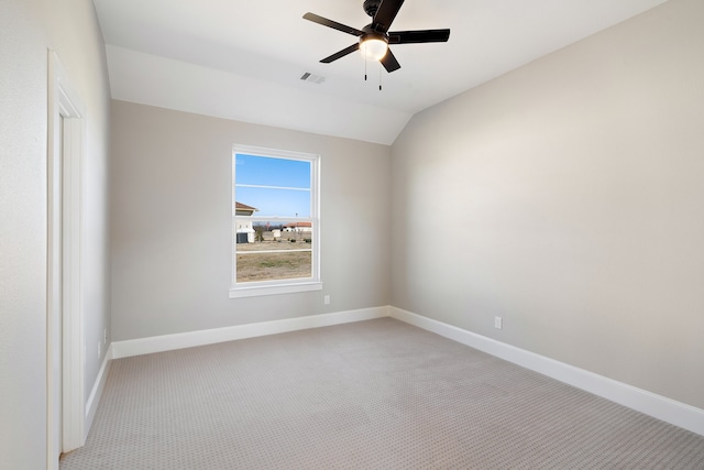 unfurnished room featuring light carpet, lofted ceiling, and ceiling fan