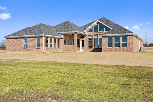 back of house featuring a yard and central AC unit