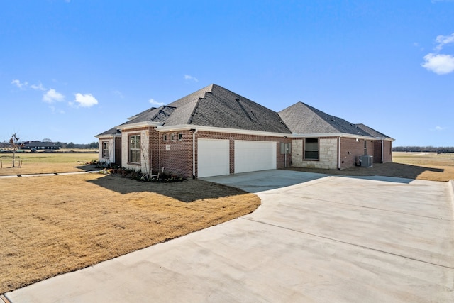 view of front of property featuring central air condition unit and a garage