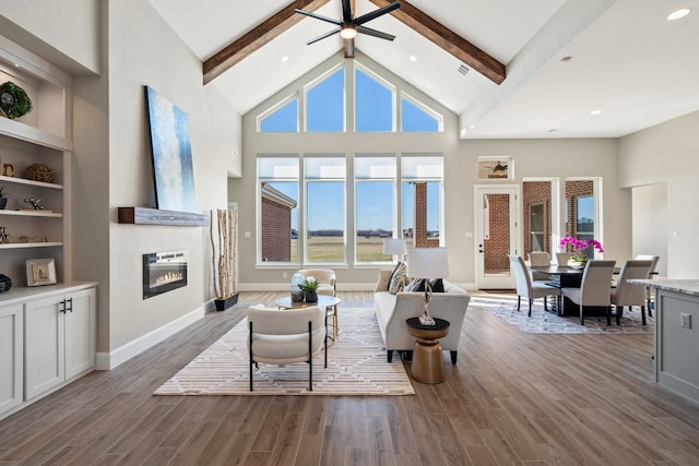 living room with beamed ceiling, dark wood-type flooring, and high vaulted ceiling