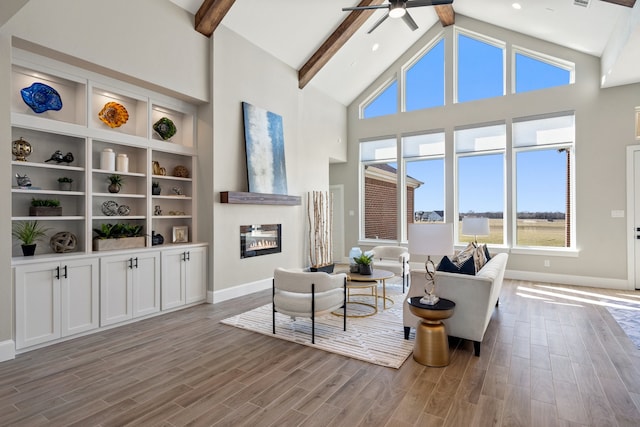 living room featuring light hardwood / wood-style floors and beamed ceiling