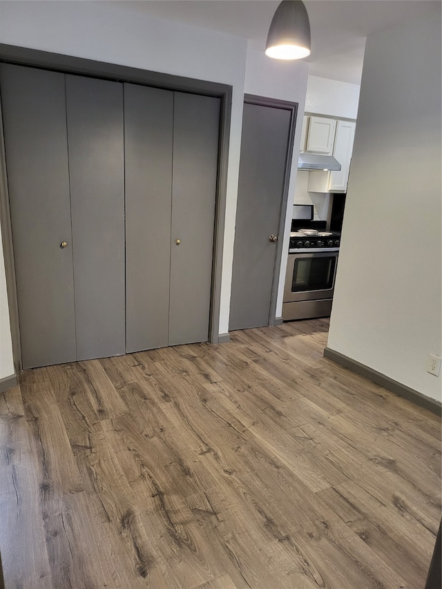 unfurnished bedroom with light wood-type flooring