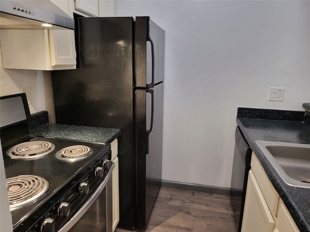 kitchen with sink, appliances with stainless steel finishes, range hood, and dark hardwood / wood-style flooring