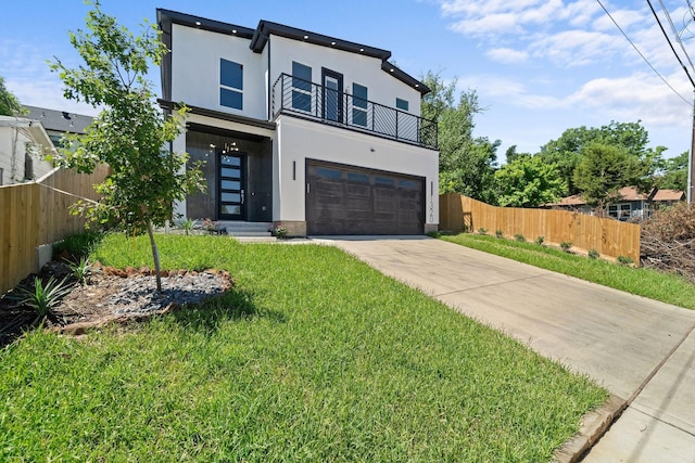 modern home featuring a front yard, a garage, and a balcony