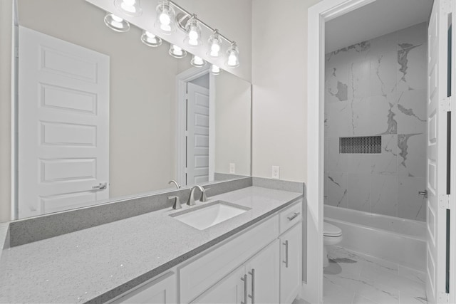 full bathroom with vanity, tiled shower / bath combo, and toilet