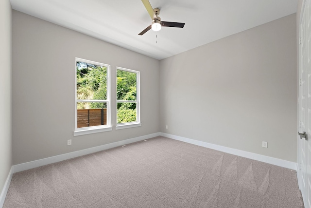 carpeted spare room with ceiling fan