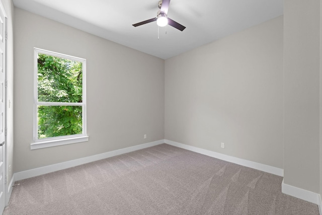 empty room with ceiling fan and light colored carpet