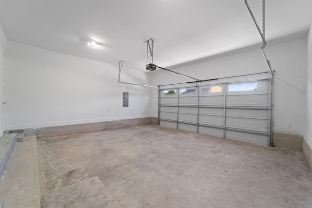 garage with a garage door opener and electric panel