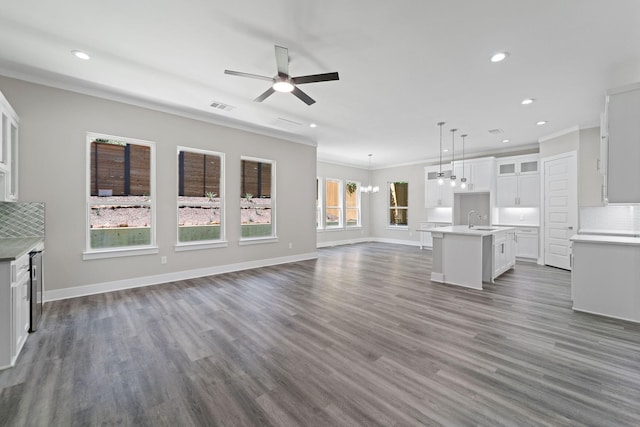 unfurnished living room featuring ornamental molding, sink, ceiling fan, and dark hardwood / wood-style floors