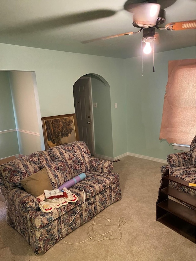 living room with light colored carpet and ceiling fan