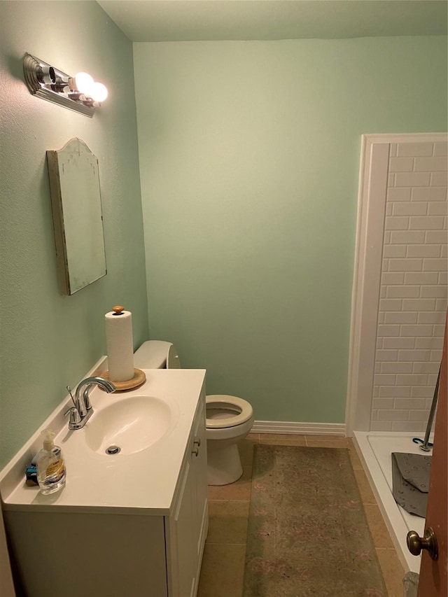 bathroom with tile patterned floors, vanity, toilet, and walk in shower