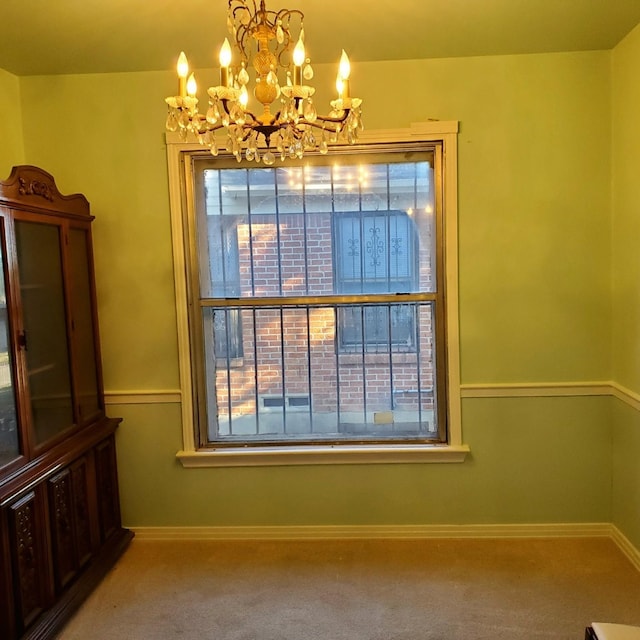 carpeted dining space with a notable chandelier