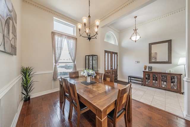 dining room with a chandelier, wood-type flooring, and crown molding