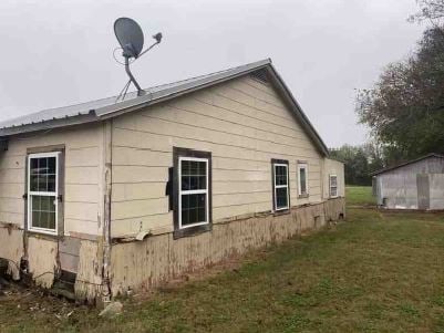 view of property exterior featuring a lawn