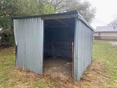 view of outbuilding with a lawn