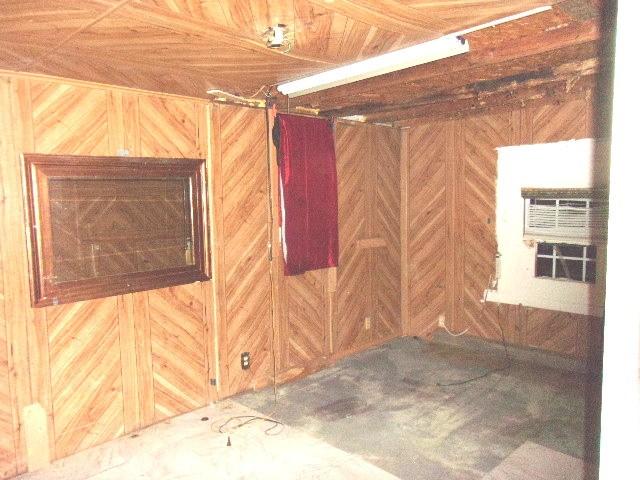11114 E State Highway 31, Kerens, TX 75144 - below grade area with wood walls and a wall mounted air conditioner