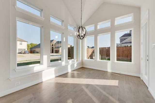 unfurnished sunroom featuring a notable chandelier and a wealth of natural light