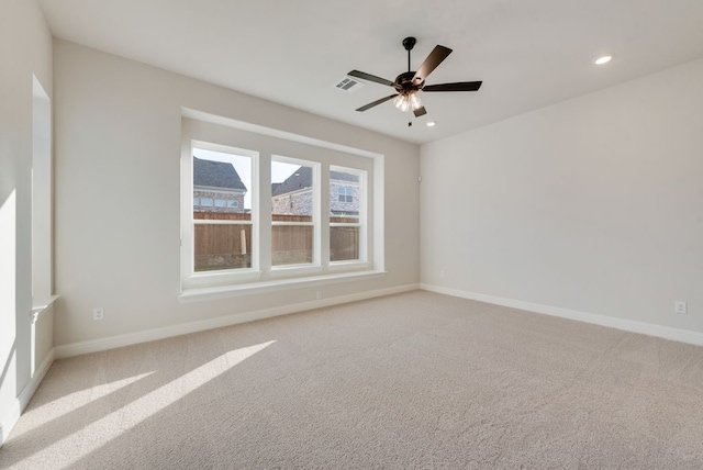 carpeted spare room with ceiling fan