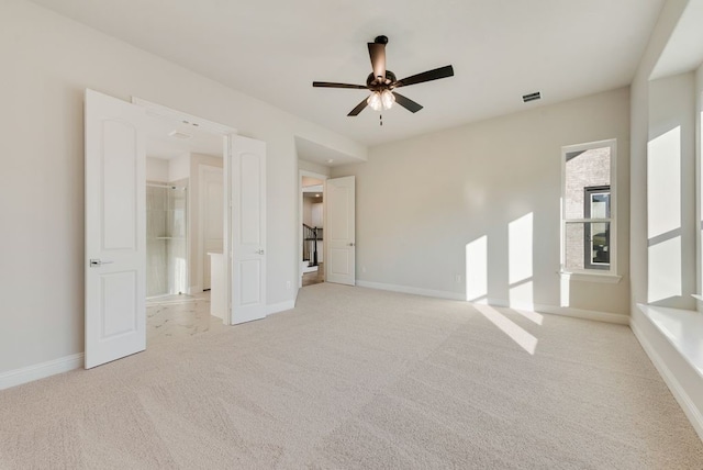 unfurnished bedroom with ceiling fan, light carpet, and a spacious closet