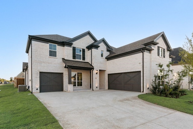 view of front of home featuring a front lawn, a garage, and central AC unit