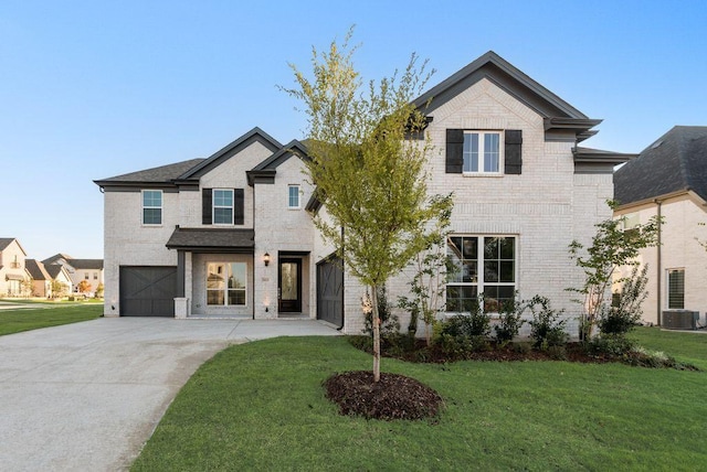 view of front of property featuring brick siding, concrete driveway, a garage, cooling unit, and a front lawn