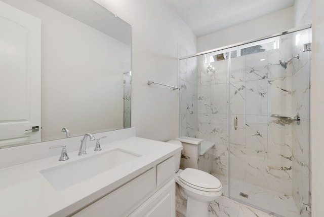 bathroom featuring vanity, toilet, and a shower with shower door