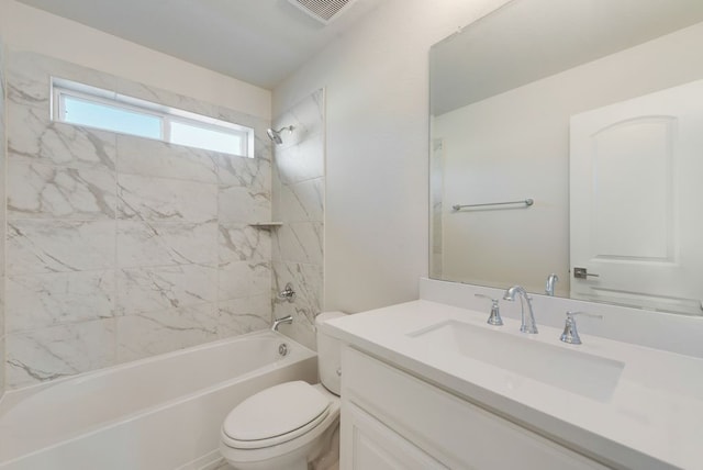 full bathroom with vanity, tiled shower / bath combo, and toilet