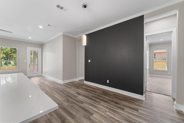 unfurnished living room featuring dark hardwood / wood-style floors and crown molding