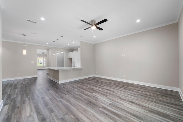 unfurnished living room featuring crown molding, ceiling fan, and hardwood / wood-style flooring