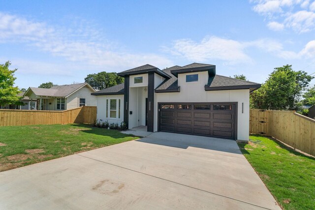 view of front facade with a garage and a front lawn