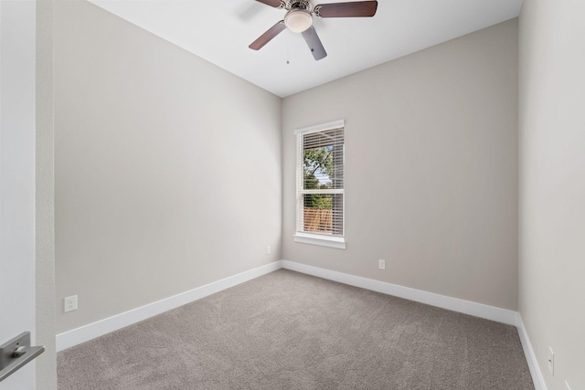 carpeted spare room with ceiling fan