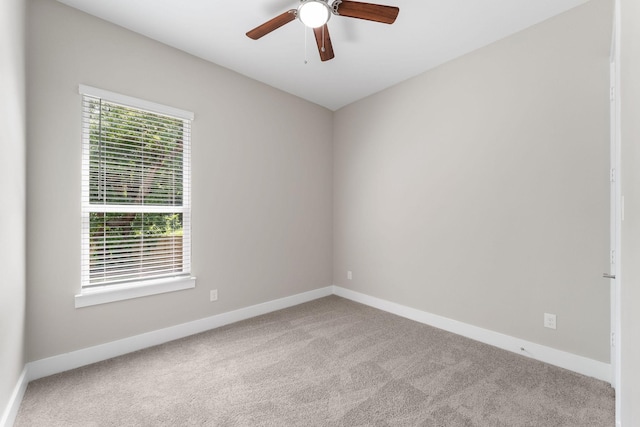 empty room featuring light colored carpet and ceiling fan