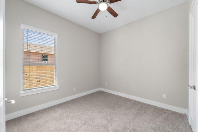 carpeted spare room with ceiling fan