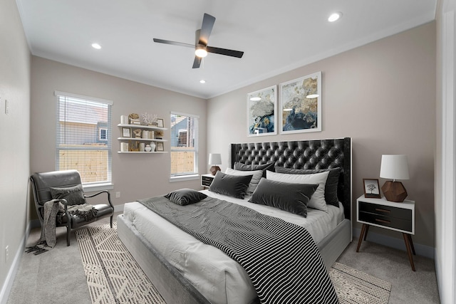 bedroom with multiple windows, ceiling fan, light colored carpet, and ornamental molding